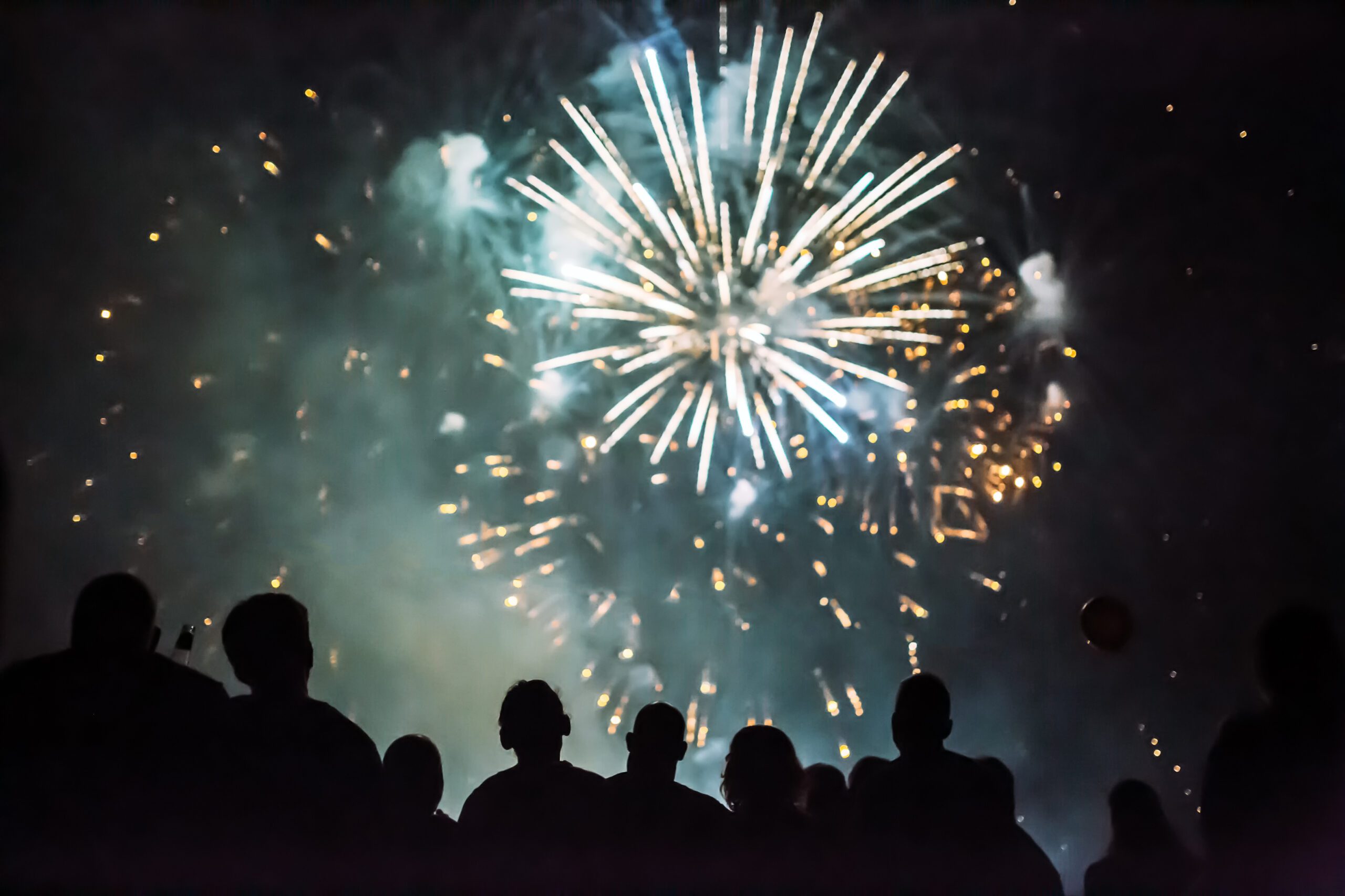 Crowd watching fireworks and celebrating new years eve